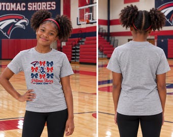 May include: A heather gray short-sleeve t-shirt featuring a graphic print of red and blue bows, a small eagle logo, and the text Potomac Shores Dance Team. The back of the shirt is plain heather gray with no additional graphics or text.