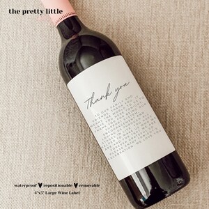 May include: A white wine bottle label with black text that reads "Thank you to our family and friends, thank you. It means the world to us to have you here tonight. Thank you for being our support system. Encouragement and loving us through all stages in life, you have helped to make us who we are and for that we are forever grateful. So please enjoy tonight's celebration. We love you."