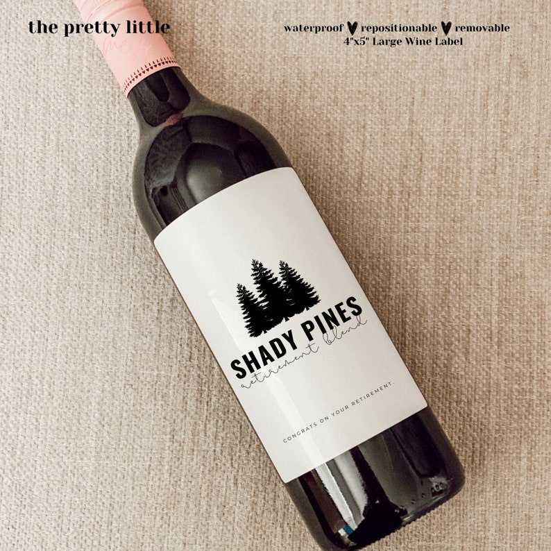May include: A black and white wine bottle label with a design of pine trees and the text "Shady Pines retirement blend". The label also includes the text "Congrats on your retirement."