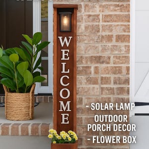 May include: A rustic cedar welcome planter with a solar lamp and flower box. The brown wooden planter has the word "WELCOME" in white letters. Yellow flowers are in the flower box. The text "SOLAR LAMP OUTDOOR PORCH DECOR - FLOWER BOX" is also visible.