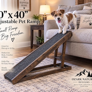 May include: A dark brown wooden adjustable pet ramp measuring 10 inches by 40 inches with a textured black non-slip surface. The ramp features text including 10 x 40 Adjustable Pet Ramp, Small Ramp. Big Freedom., and Ozark Natural Designs.