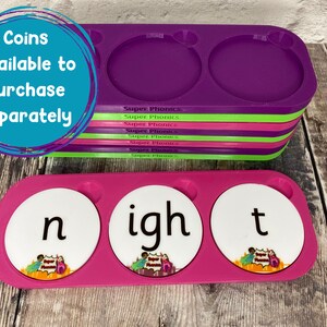 Pu&ograve; includere: Un vassoio rosa con tre fessure rotonde, ciascuna contenente un cerchio bianco con una lettera. Le lettere compongono la parola "night". Il vassoio &egrave; etichettato "Super Phonics" ed &egrave; impilato su diversi altri vassoi di colori diversi.