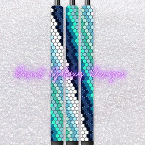 May include: Three stylus pens with a mosaic pattern in shades of blue, teal, and white. The pens have a black tip and a silver top. The text "Desert Galaxy Designs" is written in a cursive font.