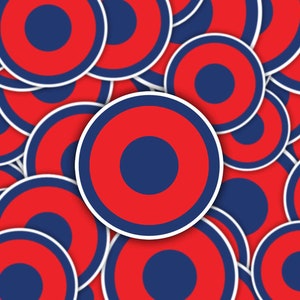 May include: A pattern of overlapping red and blue circles with white outlines. The circles are arranged in a random pattern, creating a visually appealing design.