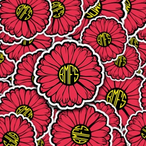 May include: A sheet of red and white daisy stickers with the monogram "BMFS" in black and yellow in the center of each daisy.