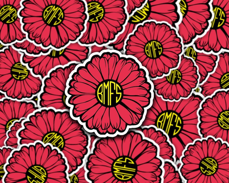Red Daisy with yellow letters in center that read BMFS.