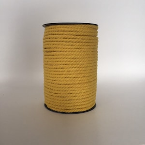 May include: A spool of yellow cotton rope.