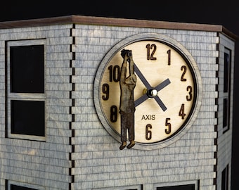 May include: A wooden clock tower with a gray brick facade and a clock face with a figure holding binoculars. The clock face reads "AXIS" and has Roman numerals for the hours.