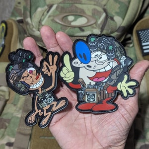May include: Two cartoon character patches, one is a brown monkey wearing a tactical vest and holding a peace sign, the other is a white cartoon character wearing a red jumpsuit and tactical gear, both patches have black outlines.
