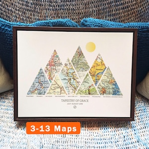 May include: Framed artwork featuring mountain-shaped map segments. Each triangle displays a different city map, including Las Vegas and New York City. The artwork is titled "Tapestry of Grace" and includes the text "3-13 Maps".