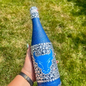 SUNY Buffalo bottle with blue glitter.