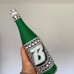 SUNY Binghamton bottle with green glitter.