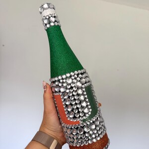 University of Miami bottle with green and orange glitter.