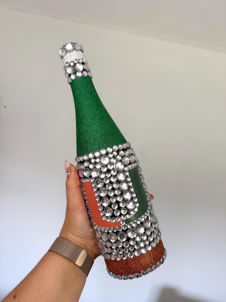 University of Miami bottle with green and orange glitter.
