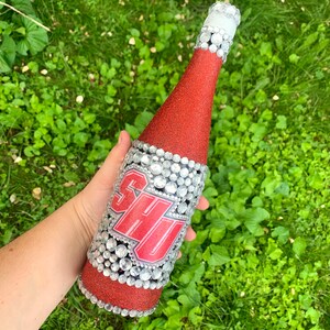 Sacred Heart University bottle with red glitter.