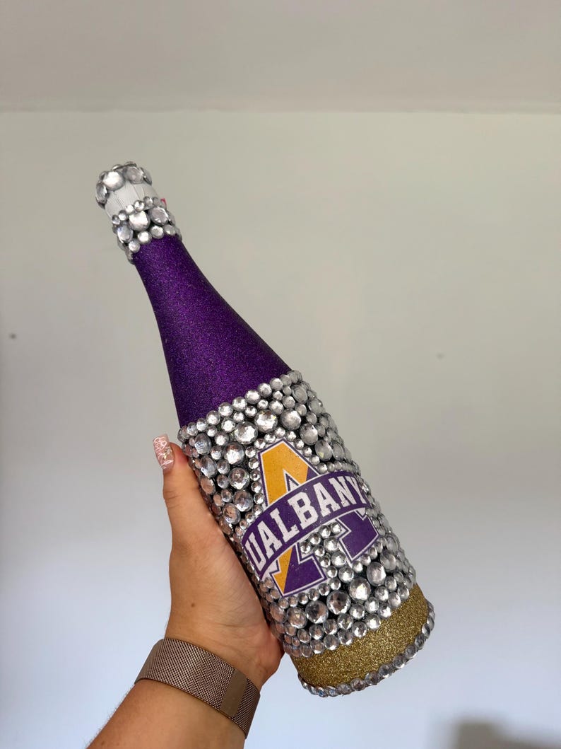 SUNY Albany bottle with purple and gold glitter.