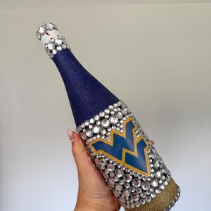University of West Virginia bottle with navy and gold glitter.