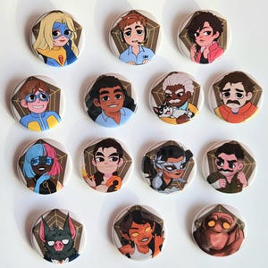 May include: A collection of round, colorful buttons featuring various cartoon character illustrations. Each button has a unique design, including superheroes, people with headsets, and other stylized figures. The buttons are arranged on a white surface.