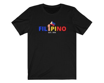 May include: Black t-shirt with a red, blue, and yellow graphic of a hand holding a Philippine flag. The text "FILIPINO EST. 1954" is below the graphic.