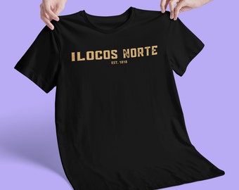 May include: Black t-shirt with a gold graphic that says "ILOCOS NORTE EST. 1818"