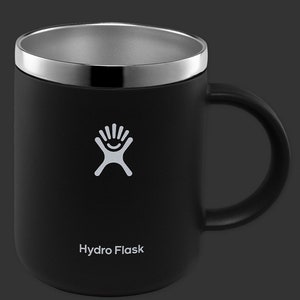 May include: A black Hydro Flask travel mug with a stainless steel lid and a white logo. The mug has a handle and is made of double-walled stainless steel.