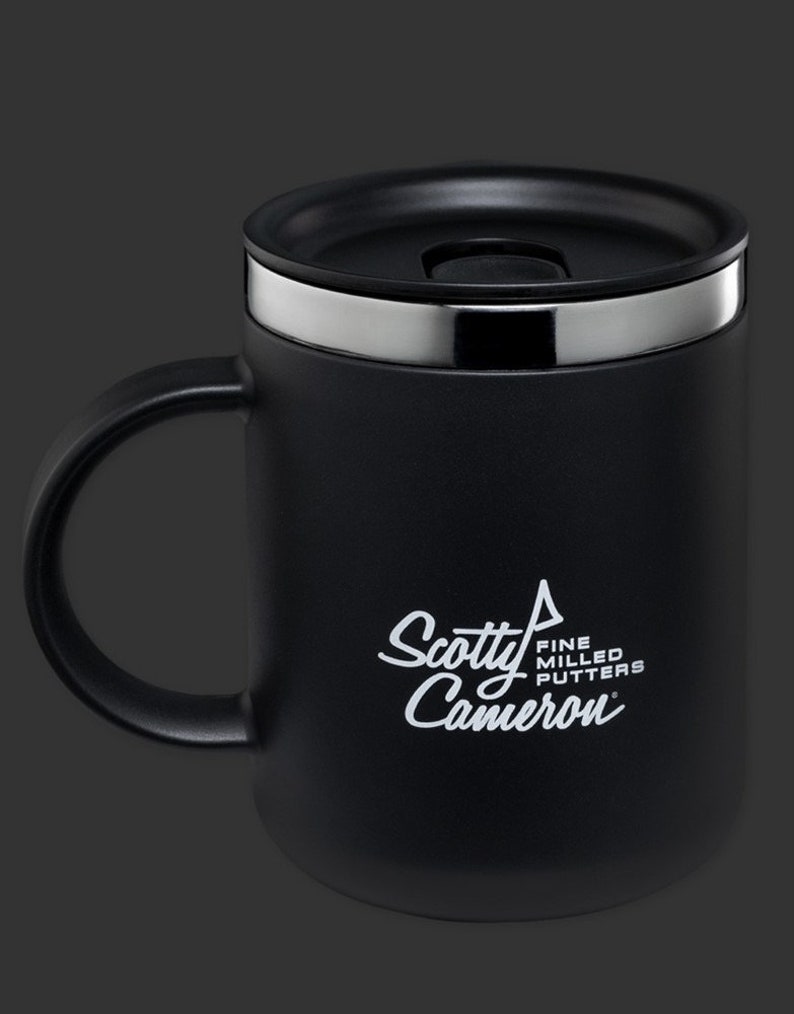 May include: Black travel mug with a silver lid and a white logo that says "Scotty Cameron Fine Milled Putters".