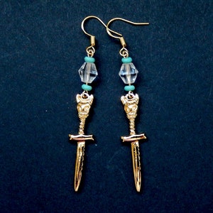 May include: Gold sword earrings with clear crystal and turquoise beads.