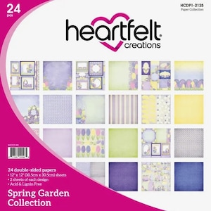 May include: A package of 24 double-sided 12" x 12" paper sheets from the "Spring Garden Collection" by Heartfelt Creations. The paper features various floral and patterned designs in pastel colors, including lavender, yellow, and green. The package is acid and lignin free.