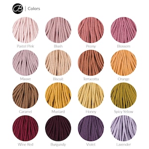May include: A color chart showing 16 different colors of cotton cord. The colors are arranged in four rows of four. The colors are: Pastel Pink, Blush, Peony, Blossom, Mauve, Biscuit, Terracotta, Orange, Caramel, Mustard, Honey, Spicy Yellow, Wine Red, Burgundy, Violet, and Lavender.