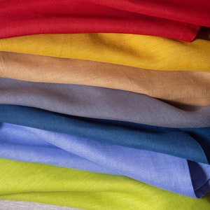 Colorful linen napkins styled in a vibrant mix of earthy and modern shades, beautifully arranged for elegant table styling and sustainable home decor. Soft washed organic linen fabric with natural texture, reusable eco friendly dinner napkins perfect for weddings, dinner parties. Handmade linen table textiles in a curated color palette including green, terracotta, blue, blush and natural tones, ideal for rustic tablescapes, cottagecore kitchens, minimalist homes and timeless luxury hosting.