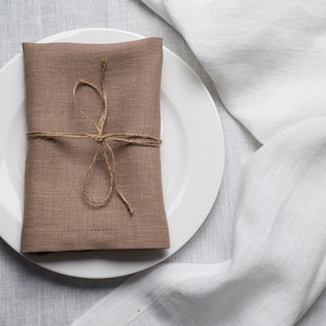 Oat organic linen napkins in a soft warm neutral shade, perfect for timeless table styling, minimalist interiors and elegant sustainable home decor. Soft washed reusable linen fabric with natural texture and refined mitered corners, designed for weddings, farmhouse dining, rustic tablescapes and everyday hosting. Handmade eco friendly dinner napkins in a calming oat beige tone that pairs beautifully with natural ceramics, wooden decor and modern neutral table settings for cozy dining experiences