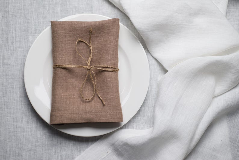 Oat organic linen napkins in a soft warm neutral shade, perfect for timeless table styling, minimalist interiors and elegant sustainable home decor. Soft washed reusable linen fabric with natural texture and refined mitered corners, designed for weddings, farmhouse dining, rustic tablescapes and everyday hosting. Handmade eco friendly dinner napkins in a calming oat beige tone that pairs beautifully with natural ceramics, wooden decor and modern neutral table settings for cozy dining experiences