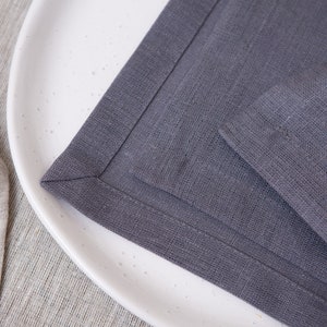 Grey organic linen napkins with elegant mitered corners. Soft washed linen fabric with a refined natural texture, designed for modern table settings, minimalist interiors, farmhouse dining and timeless sustainable home decor. Mitered corners create a clean luxury finish with perfectly folded edges, giving the napkins a more sophisticated and high quality look. Reusable eco friendly dinner napkins handmade for weddings, holiday entertaining, everyday dining, rustic tablescapes and elegant hosting