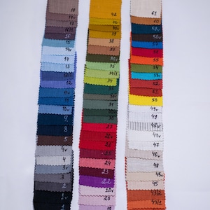 Samples of organic linen napkins in different color palette for modern table styling and sustainable home decor. Soft fabric with natural texture, eco friendly reusable dinner napkins for weddings, hosting, farmhouse table settings, minimalist interiors, holiday entertaining, handmade table linens available in multiple shades green, terracotta, blue, lavender, natural beige, olive. Elegant napkins for everyday dining, rustic table decor, cottagecore kitchen and luxury organic home textiles.