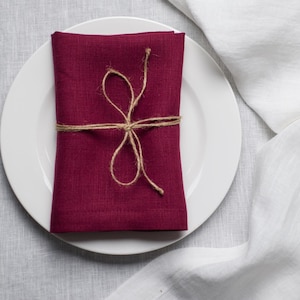 Plum organic linen napkins in a rich deep shade, perfect for elegant table styling, romantic dinners, autumn entertaining and luxury home decor. Soft washed reusable linen fabric with natural texture and refined mitered corners, designed for weddings, farmhouse dining, cottagecore interiors and modern minimalist tablescapes. Handmade eco friendly dinner napkins in a timeless plum color that adds warmth, depth and sophistication to everyday dining, holiday gatherings, sustainable table settings