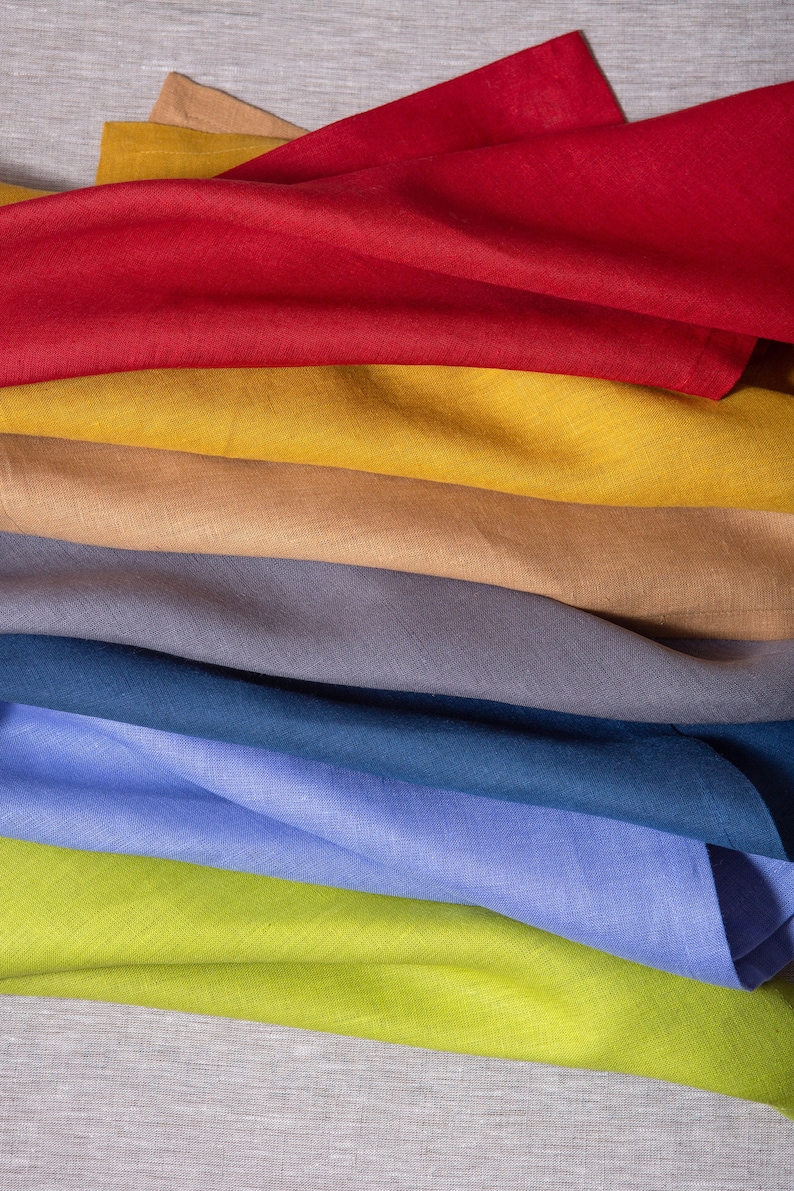 Colorful linen napkins styled in a vibrant mix of earthy and modern shades, beautifully arranged for elegant table styling and sustainable home decor. Soft washed organic linen fabric with natural texture, reusable eco friendly dinner napkins perfect for weddings, dinner parties. Handmade linen table textiles in a curated color palette including green, terracotta, blue, blush and natural tones, ideal for rustic tablescapes, cottagecore kitchens, minimalist homes and timeless luxury hosting.