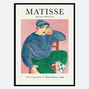 May include: A framed art print of "The Young Sailor II" by Henri Matisse. The artwork depicts a person in a blue sweater, green pants, and a cap, seated on a wooden chair. The background is pink, and the print includes the text "MATISSE" and "Museum of Modern Art."
