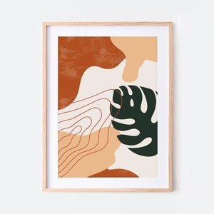May include: Abstract art print with a green leaf, orange, peach, and white shapes. The print is framed in a light wood frame.