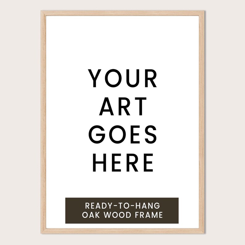a simple, minimalist design with the text "YOUR ART GOES HERE" in a bold, black font. Below the text, there is a smaller caption that reads "READY-TO-HANG OAK WOOD FRAME".