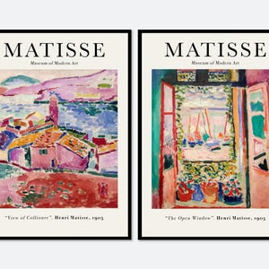 May include: Two framed art prints featuring Henri Matisse paintings. The left print shows View of Collioure with pink buildings and blue water. The right print shows The Open Window with a view of boats. Both feature the text MATISSE Museum of Modern Art.