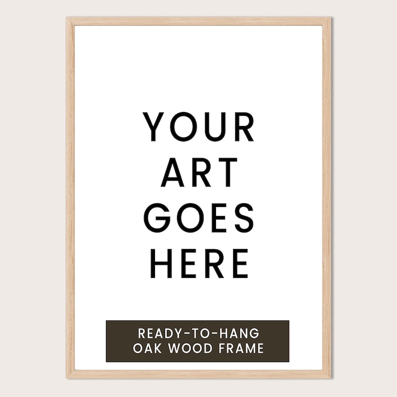 a simple, minimalist design with the text "YOUR ART GOES HERE" in a bold, black font. Below the text, there is a smaller caption that reads "READY-TO-HANG OAK WOOD FRAME".