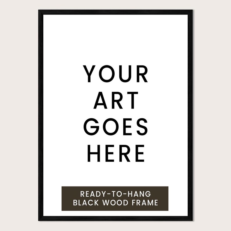 a black and white text-based design with the phrase "YOUR ART GOES HERE" prominently displayed. Below the main text, there is a smaller text that reads "READY-TO-HANG BLACK WOOD FRAME".