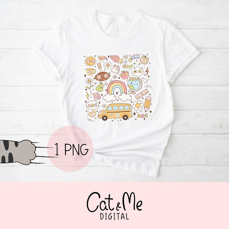 May include: A white t-shirt with a colorful graphic design featuring a school bus, rainbow, and other back-to-school themed elements. The design includes the letters "ABC" and a heart.