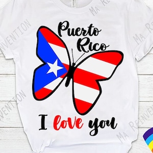 May include: White t-shirt featuring a butterfly design in the colours of the Puerto Rican flag. The butterfly has the words "Puerto Rico" above it and "I love you" below it.