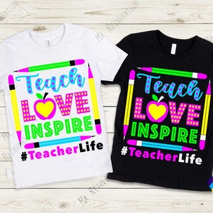 May include: Two t-shirts with a colourful graphic design. The design features the words "Teach Love Inspire" with a red apple and colourful pencils. The text "#TeacherLife" is below the design. One t-shirt is white and the other is black.