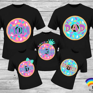 May include: Set of five black t-shirts with donut designs. The donuts have pink, blue, and yellow frosting with colorful sprinkles. The shirts say "Mom", "Dad", "Birthday Princess", "Sister", and "Brother".