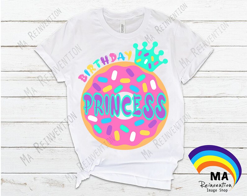 May include: White t-shirt with a pink and orange donut with sprinkles and the text "Birthday Princess" in colorful letters. A blue crown with white stars is above the donut.