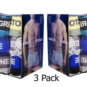 May include: A three-pack of men's underwear in a clear plastic package. The underwear is gray, blue, and black with the word "GREY STONE" printed on the package.