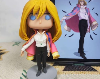 May include: A hand-painted figurine of a character with long blonde hair, wearing a pink and white robe, black pants, and a green gem. The figurine is standing on a gray base. The background shows a digital illustration of the same character.