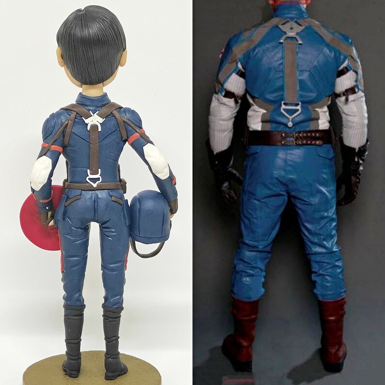 May include: A blue and red superhero action figure with a helmet and shield. The figure is wearing a blue and red suit with a brown belt and a white strap across the chest.